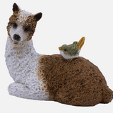 Brown and White Laying Llama With Bird Figurine